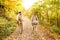 Young couple in warm clothes cycling in autumn park.