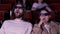 Young couple watching horror movie in 3D glasses. Media. Man and woman looking frightened and shocked while watching