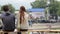 Young couple watching show sitting bench, rock concert contest