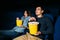 Young couple watching a thriller movie in cinema. Date