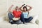 Young couple watching tv sport football game excited celebrating