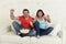 Young couple watching tv sport football game excited celebrating