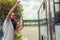 Young couple waving goodbye to their friends on the bus