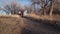 Young couple wearing face masks is walking on a gravel bike