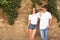 Young couple wearing white t-shirts near stone wall