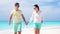 Young couple on white beach during summer vacation. Happy family enjoy their honeymoon. SLOW MOTION VIDEO.