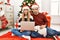 Young couple of wife and husband wearing christmas hat using laptop thinking attitude and sober expression looking self confident