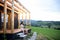 Young couple with wine outdoors, weekend away in container house in countryside.