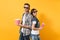 Young couple woman man in 3d glasses watching movie film on date holding bucket of popcorn plastic cup of soda or cola