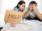 Young couple worried at home in bad financial situation stress asking for help