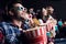 young couples in 3d glasses with popcorn and soda watching movie