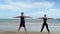 Young couples doing exercise in the beach in the morning