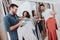 Young Couples in Dressing Room in Modern Boutique.