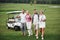 Young couples getting ready to play. A group of smiling friends came to the hole on a golf cart