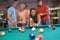 Young couples playing pool in a bar