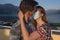 Young couples wear a protective mask and kiss on the terrace of their home