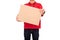 Young courier dressed in red T-shirt with name tag holding parcel isolated on white background. Delivery service concept