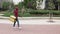 Young courier man carrying thermal backpack while walking in the city