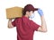 Young couriers wear medical masks  during the covid-19 epidemic. The package is carried on the shoulder, and the hand  touching th