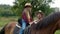 A young cowboy and his sweet daughter on horseback