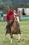 Young cowboy on horse back in Ecuador throwing lasso