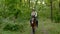 Young cowboy on horseback in the forest