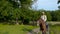 Young cowboy on horseback on a forest road