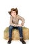 Young cowboy on straw bale