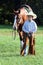 Young cowboy walking horse