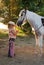 Young cowgirl with pony.