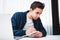 Young coworker man working at work place loft while sitting at the table