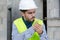 young craftsman in helmet smoking cigarette