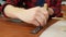 Young craftsman makes a line of markings on the leather cloth using a ruler. Handmade leather manufactures