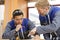 Young craftsmen in uniform working at carpentry