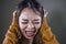 Young crazy desperate and upset Asian Korean woman screaming scared and anxious feeling anger and pain isolated on dark background