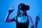 Young creative business woman, IT developer, designer using VR virtual reality glasses and gesturing in virtual world
