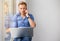 Young creative man working with computer while talking on phone