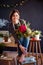 Young creative woman in a flower shop. A startup of florist business.