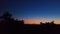 Young crescent moon on a clear sky at the end of the day in the summer