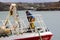 A young crew member on the bow of a trawler as she docks in Kinsale Harbor in County Cork on the south coast of Ireland.