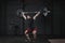 Young crossfit athlete lifting barbell overhead at gym. Man practicing functional training powerlifting workout exercises