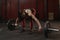 Young crossfit woman preparing barbell for lifting weight at the gym