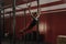 Young crossfit woman swinging on gymnastic rings