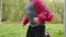 Young curly boy running on pathway in summer park. Cheerful teenager boy running in green park at summer vacation