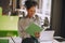 Young curly-haired woman scrutinizing the project papers