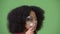 Young cute African girl with Afro hair using magnifying glass