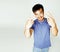 young cute asian man on white background gesturing emotional, pointing, smiling, lifestyle people concept, cheerfull