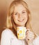 Young cute blond girl drinking coffee close up on