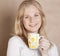 Young cute blond girl drinking coffee close up on