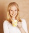 Young cute blond girl drinking coffee close up on